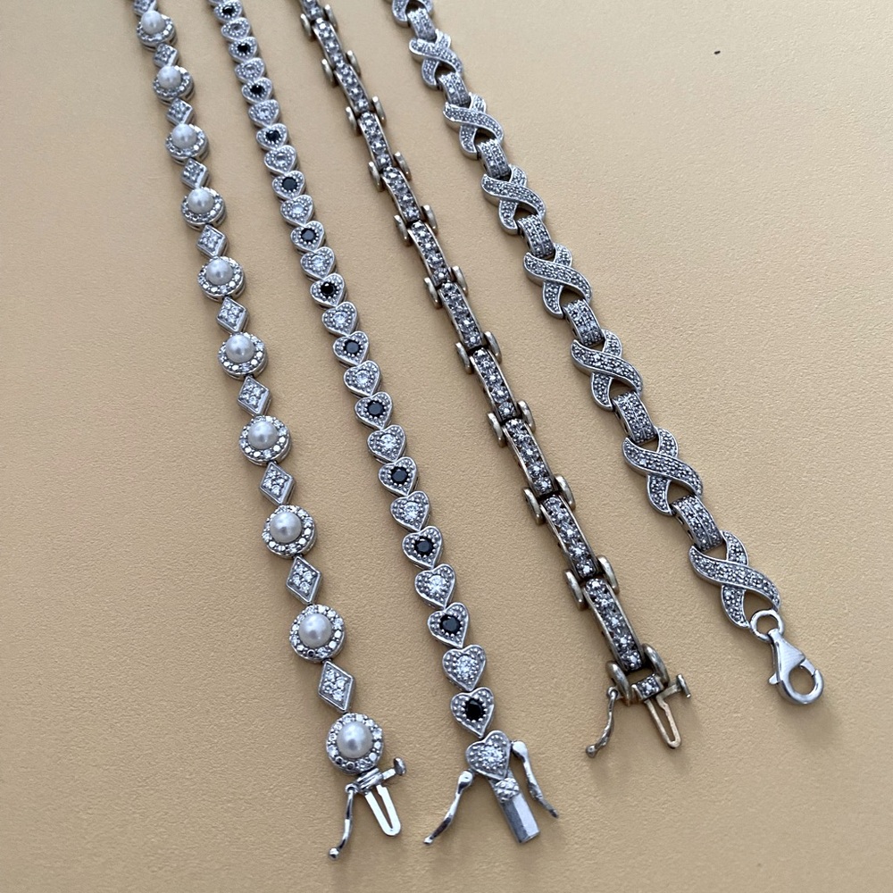 Lot of 4 Sterling with pearl, onyx and CZs bracelets. Like new.